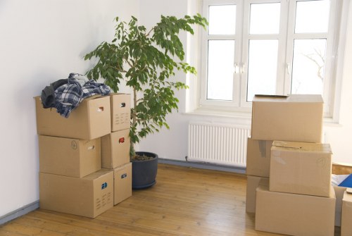 Professional movers handling packed boxes and furniture for a local move